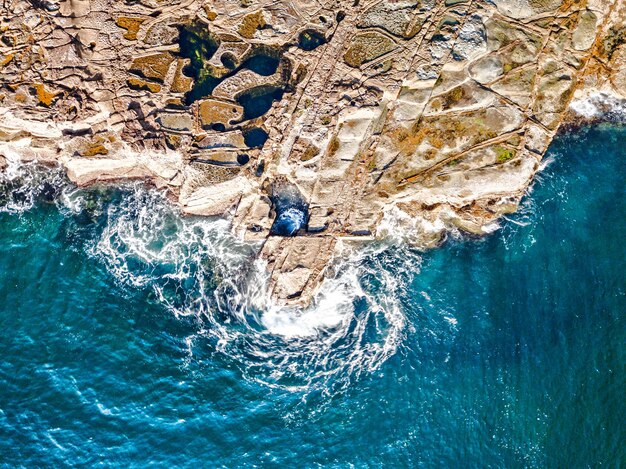 Rocks rockpools and ocean swirls