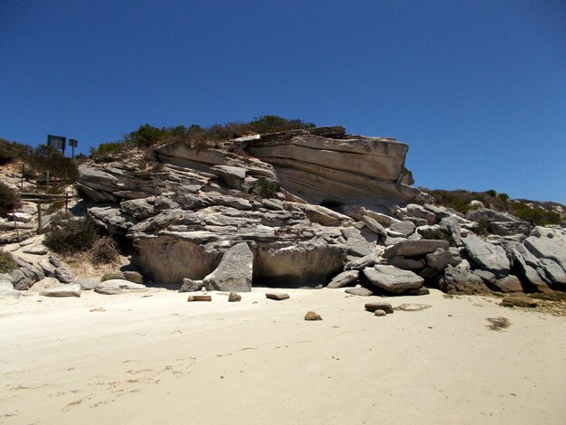 Rocks on rocks against clear blue sky