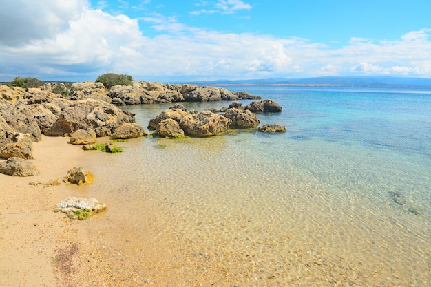 Rocks and sand in Alghero coastline Sardinia