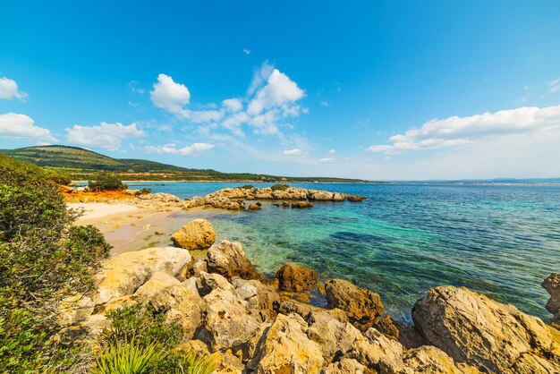 Rocks and sand in Alghero shore Sardinia