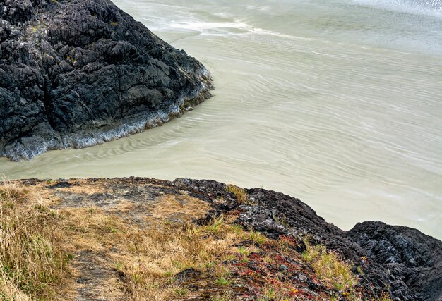 Rocks and sand on pacific ocean beach near tofino british columbia canada