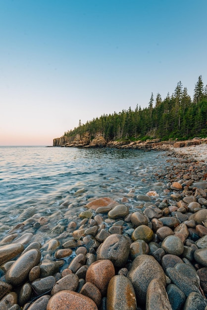 Rocks in sea against clear sky