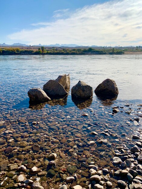 Rocks in sea against sky