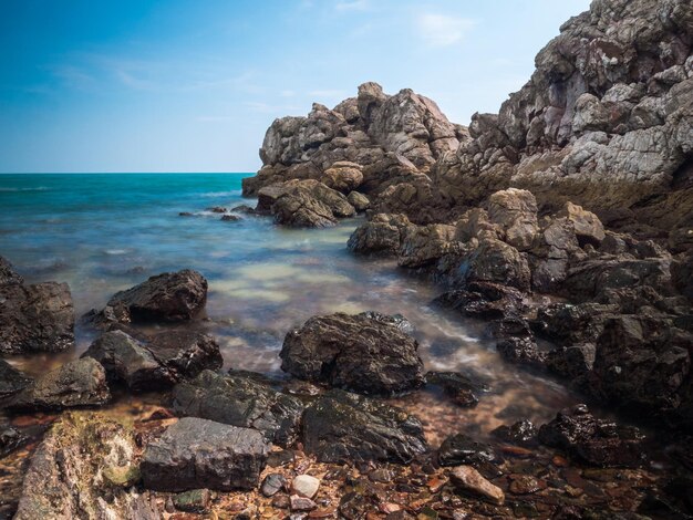 Rocks in sea against sky