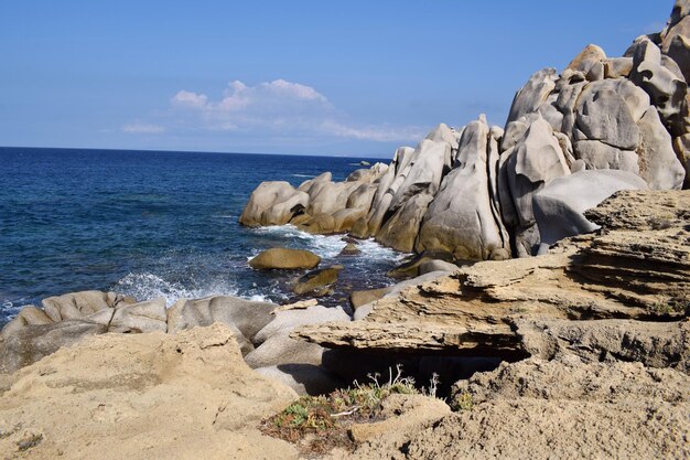 Rocks on sea shore against sky