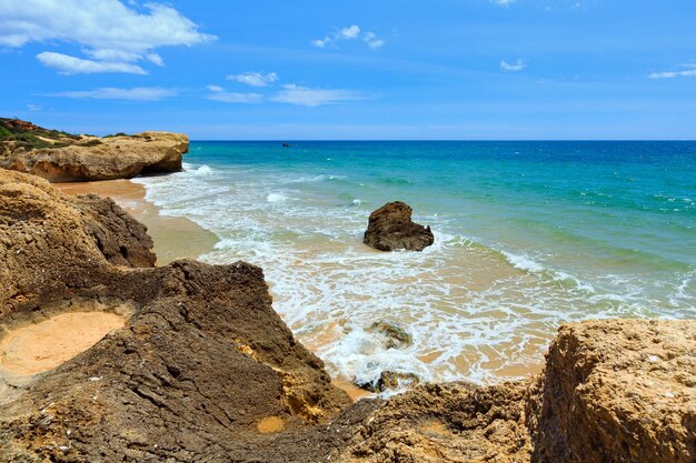 Rocks on summer sandy Albufeira beach Algarve Portugal