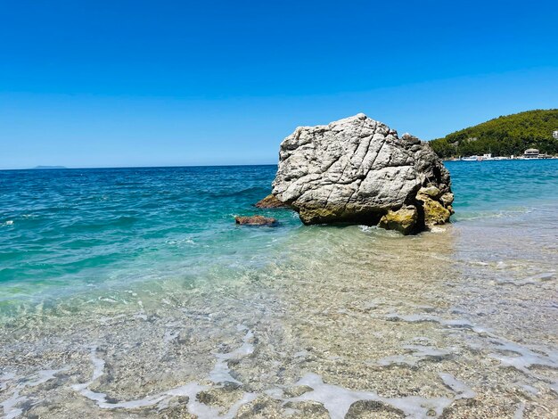 Rocky beach and crystal turquoise water of ionian sea in albania