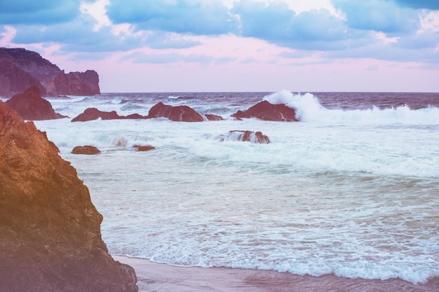 Rocky beach in the evening. Sunset over the sea. Beautiful nature