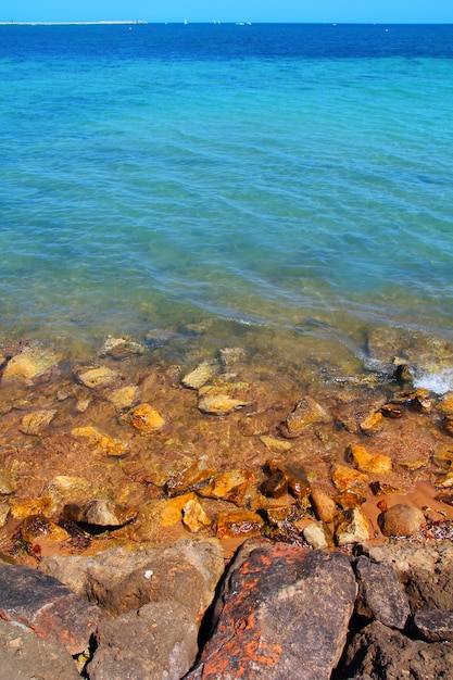 岩が多いビーチ岸ターコイズブルーの海