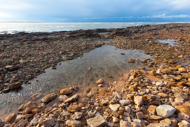 Rocky beach. sky withe clouds