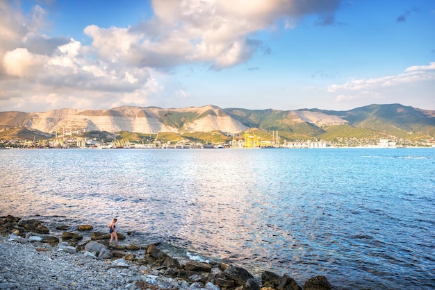 Rocky beach and sunny port Black Sea Admiral Serebryakov embankment Krasnodar Territory Novorossiysk