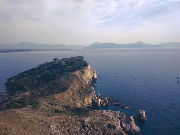 A rocky beach with a rock Steep cliff to the sea