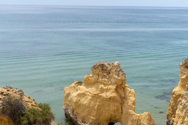 The rocky cliffs of Vale do Olival beach in Armacao de Pera Portugal