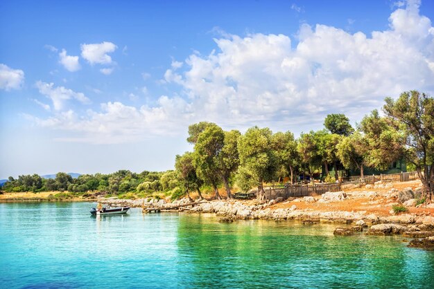 Rocky coast of Cleopatra island and boat Aegean sea Marmaris Turkiye