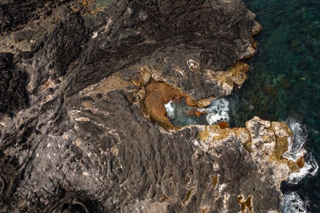 Rocky coast washed by foamy waves