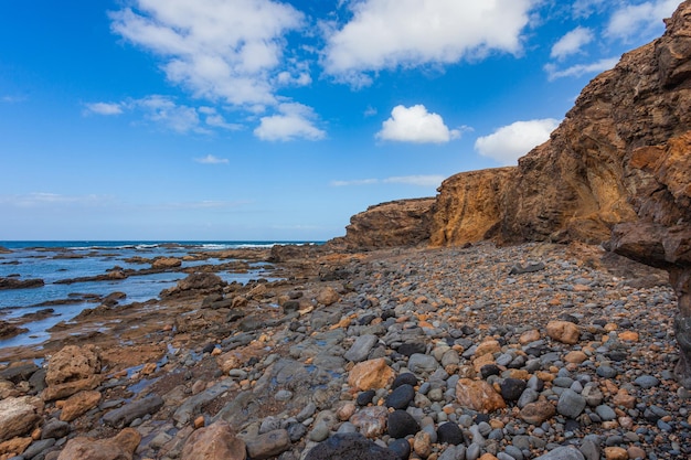 rocky escarpments that fall into the sea at Tebeto Beach in the municipality of La Oliva