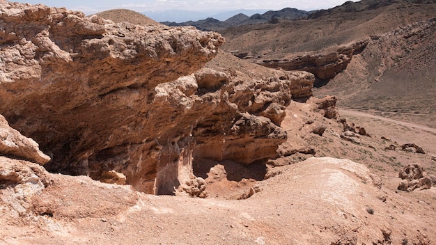 A rocky landscape with a mountain in the background