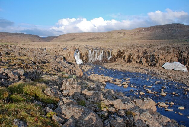 A rocky landscape with a waterfall