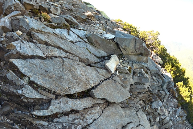 Rocky mountain hillside with big stone boulders on sunny day