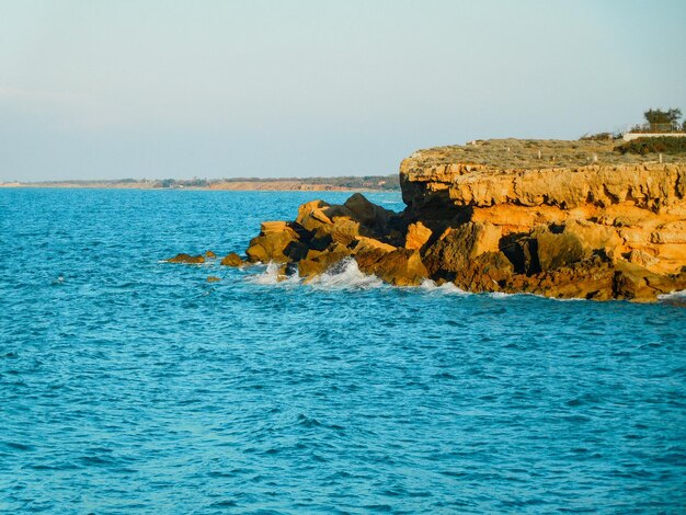 A rocky outcrop with the ocean in the background