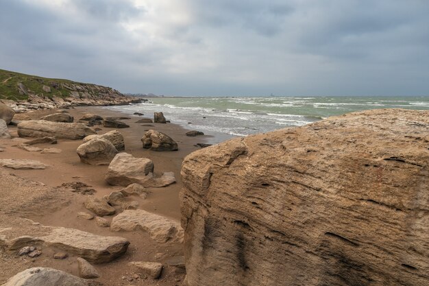 Rocky sea coast in cloudy weather