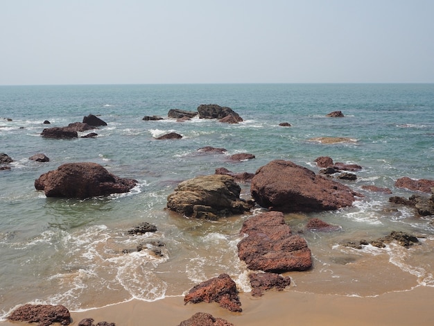 Rocky sea coast with volcanic boulders in the Indian state of Goa