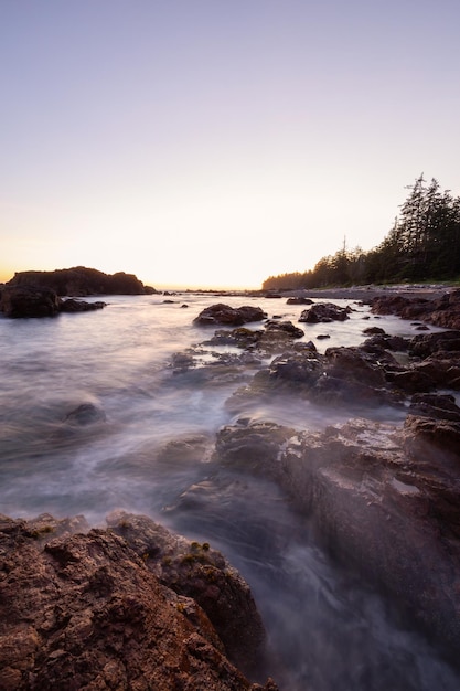 Rocky seascape on the Pacific Ocean Coast during a vibrant sunset Nature Background