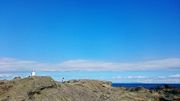 rocky shore against blue sky