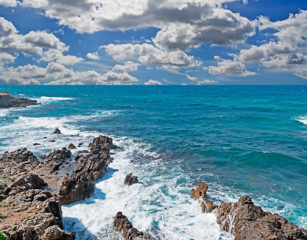 Rocky shore in Alghero under a dramatic sky