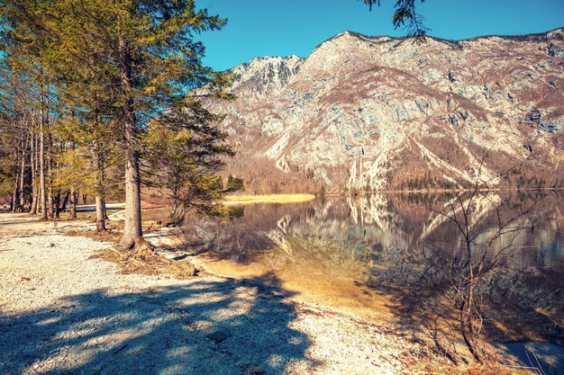 Rocky shore of the mountain lake. Beautiful nature. Reflection on the lake