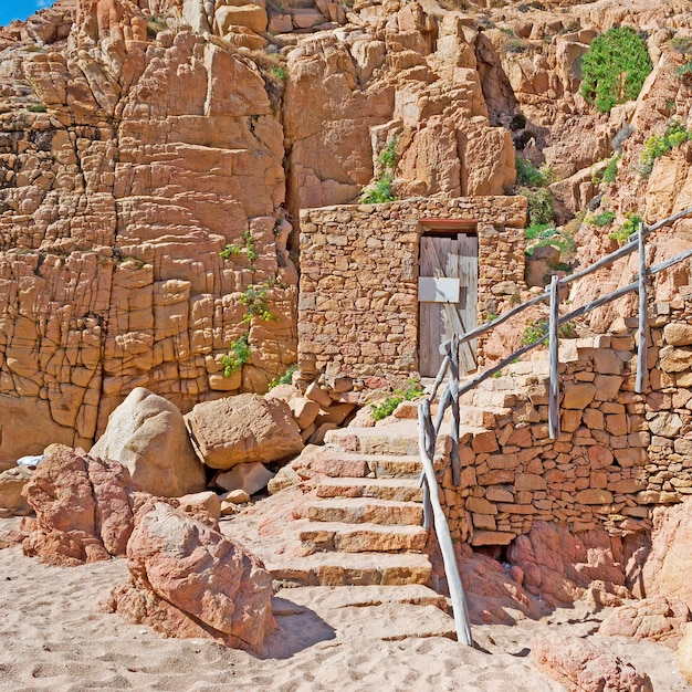 Rocky wall with a wooden door in Costa Paradiso Sardinia