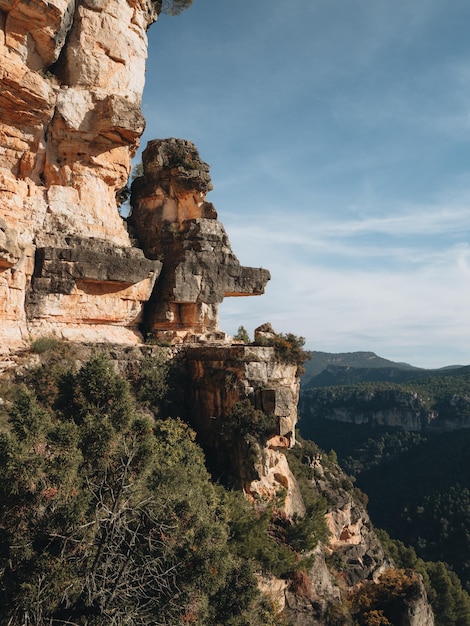 Rocky walls with reddish tones and pine forest in the Siurana mountains Tarragona Spain