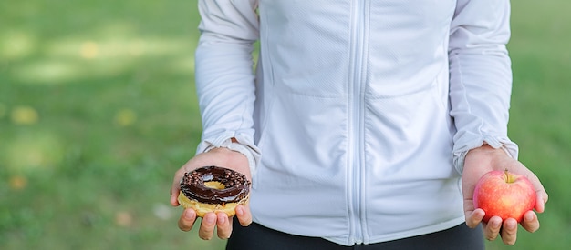 rode appel en doughnut in handen houden