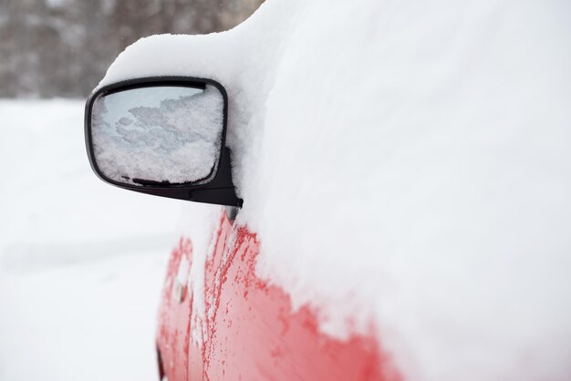 rode auto onder de sneeuw