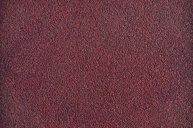Rode kastanjebruine muur met textuur op oppervlakte