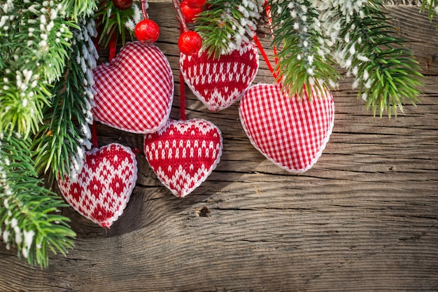 Rode kerstboomversieringen ingelijste groene tak op hout achtergrond