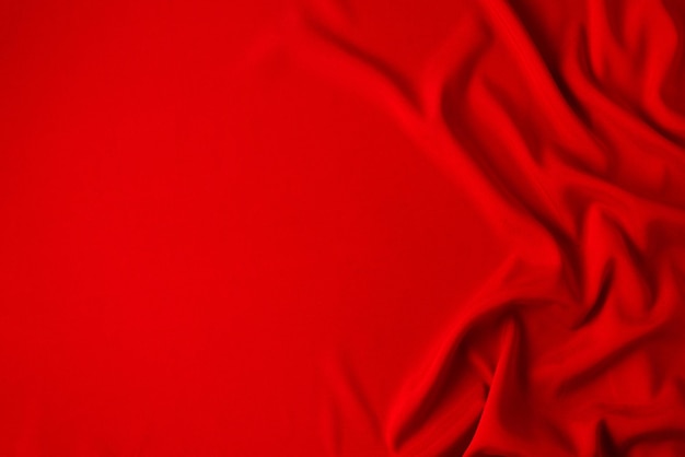Rode zijde of satijn luxe stof textuur kan gebruiken als abstracte achtergrond. Bovenaanzicht