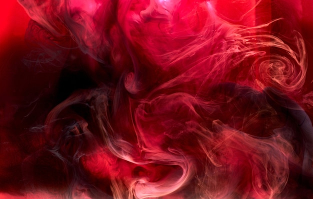 Rode zwarte pigment wervelende inkt abstracte achtergrond, vloeibare rook verf onderwater