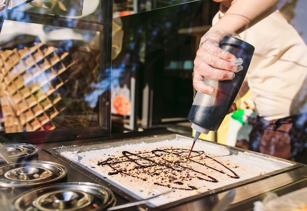 Roergebakken ijsrolletjes in de vriespan. organisch, natuurlijk gerold ijs, met de hand gemaakt dessert.