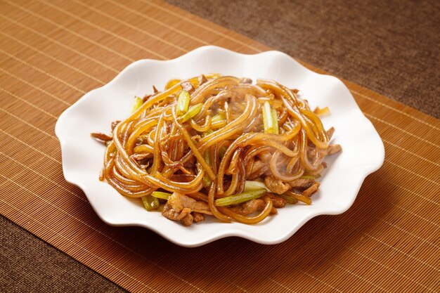 Roergebakken vermicelli met selderij een karakteristiek Chinees eten op een monochrome achtergrond