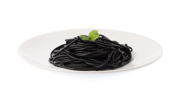 Photo roll black spaghetti pasta on a dish isolated on white background.