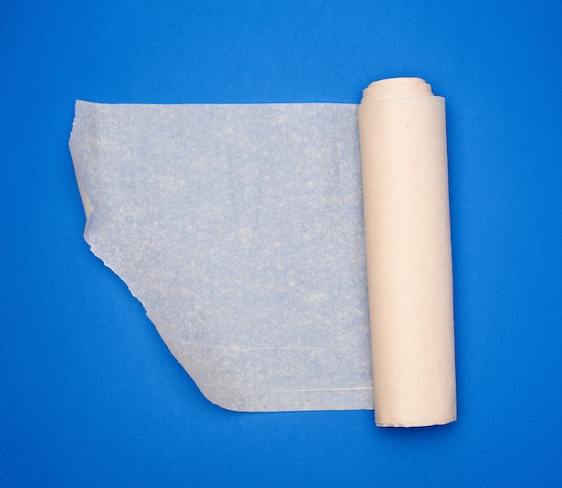 Roll of brown parchment paper on a blue surface