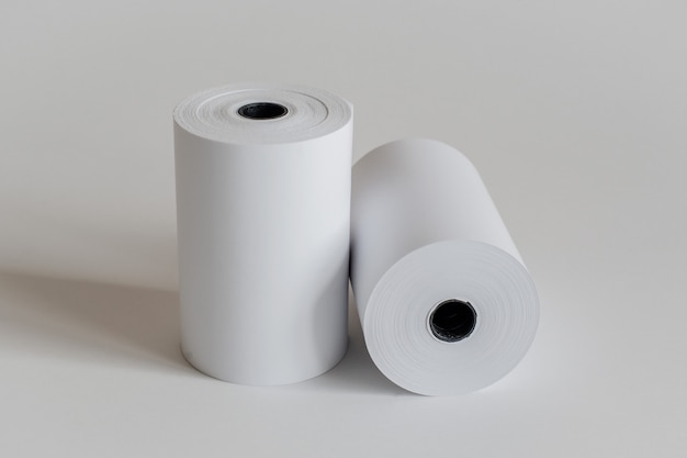 Roll of cash register tape isolated on soft gray.