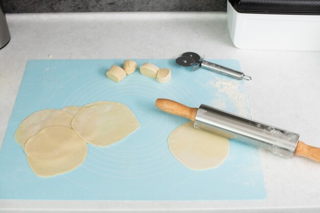 Roll and cut wheat dough on mat