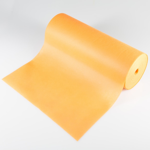 Roll of orange colored wrapping foil isolated