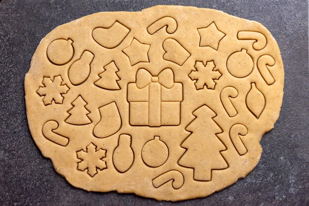 Roll out the dough for gingerbread cookies baking christmas gingerbread imprint on the dough