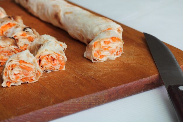 Roll of pitta bread, carrot, eggs lie