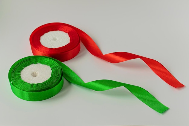 A roll of satin ribbon for decorating gifts on a white\
background silk and satin ribbon