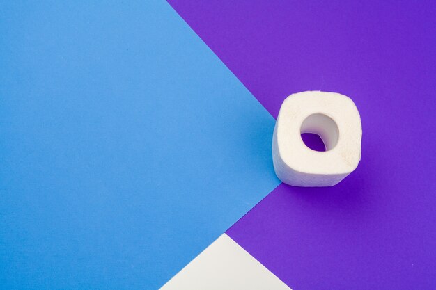 Roll of toilet paper on blue color background