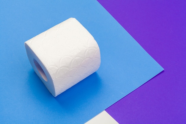 Photo roll of toilet paper on blue color background